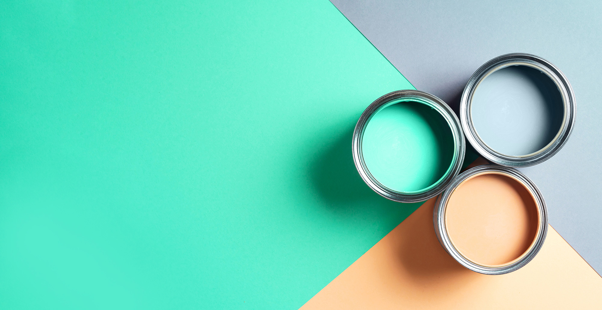 Open-cans-of-paint-on-bright-multicolored-background.-Top-view.-Copy-space